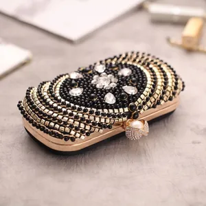 Elegant beaded evening clutch bag with crystal and pearl clasp for women parties.