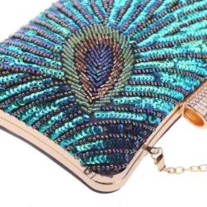 Detail shot of vintage peacock beaded evening clutch bag with sequin embroidery and gold metal frame.