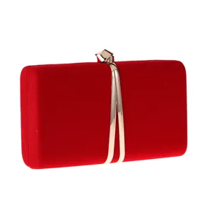 Red velvet evening clutch detail showing premium texture and elegant metallic clasp design.