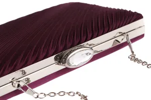 Close-up view of the elegant purple pleated evening clutch with sparkling crystal metal lock.