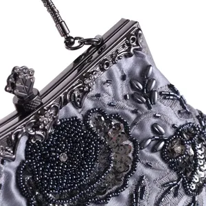 Vintage beaded evening bag detail, silver satin clutch with ornate metal frame and crystal clasp.