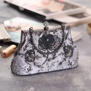 Vintage silver beaded evening bag with exquisite floral embroidery and metal clasp, perfect for parties.