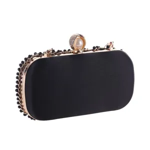 Black satin evening clutch bag with pearl rhinestone clasp and beaded chain detail.