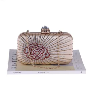 Exquisite rhinestone evening clutch bag with sparkling crystal rose pattern and metal chain strap.