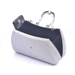 Detail view of silver glitter evening clutch bag with metallic handle and black inner lining.