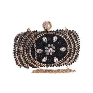 Elegant black beaded evening clutch bag with rhinestones and gold chain strap for women parties.