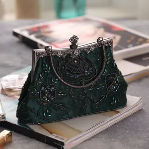 Vintage dark green beaded clutch bag with exquisite floral embroidery and metal frame.