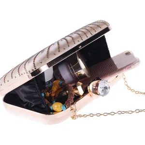 Exquisite champagne evening clutch detail showcasing rhinestone embellishments and crystal lock.