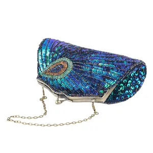 Detailed view of vintage sequin beaded clutch bag with peacock feather pattern and chain strap.