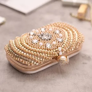 Exquisite pearl beaded evening clutch bag with sparkling rhinestones and elegant gold frame details.
