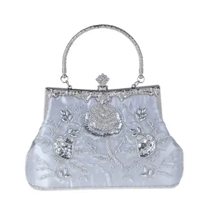 Silver beaded evening bag detail, vintage floral embroidery, elegant banquet handbag clasp.