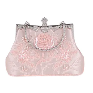 Pink satin evening bag with delicate bead embroidered rose floral design, elegant metallic clasp.