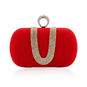 Elegant red velvet evening clutch bag with sparkling rhinestone ring clasp and crystal chain.