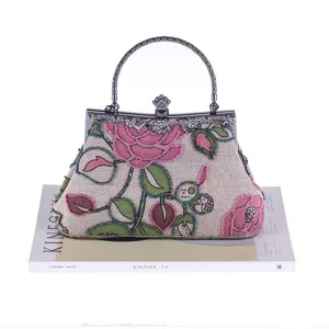 Vintage beaded evening bag with exquisite floral embroidery and metal handle for women.