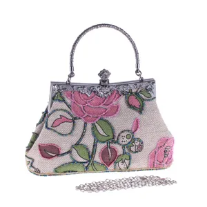 Vintage beaded evening bag with floral embroidery, metal handle and detachable chain strap.
