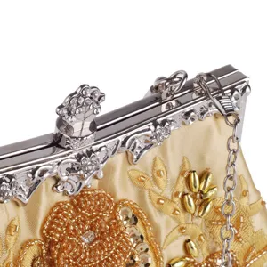 Exquisite details of vintage embroidered evening bag with sparkling beads and metallic clasp.