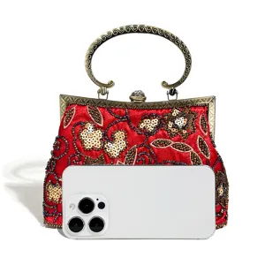 Vintage red beaded evening bag detail, sequin floral embroidery, metal kiss-lock handle design.