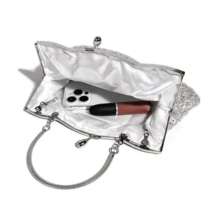 Sparkling sequin evening clutch bag detail showing interior capacity and luxury metal frame design.