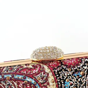 Elegant women's evening clutch bag with exquisite rhinestone clasp and vibrant floral pattern.