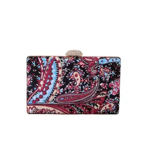 Paisley print evening clutch bag detail, elegant crystal clasp and metallic frame design.