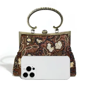 Vintage beaded evening bag detail, retro kiss-lock handbag with metal handle for parties.