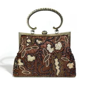 Retro beaded evening bag detail, sparkling sequin floral embroidery, vintage metal frame handle.