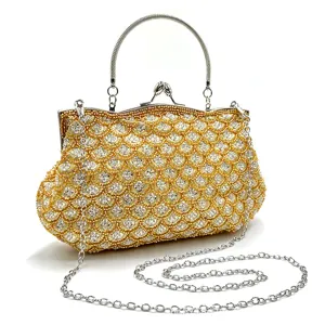 Close-up detail of the luxury beaded evening clutch bag with sparkling gold fish scale pattern.