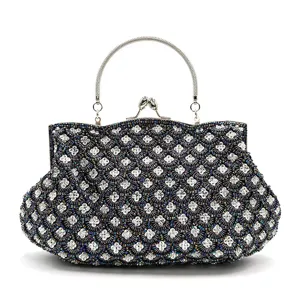 Elegant beaded evening clutch bag with metallic handle and classic clover pattern design.