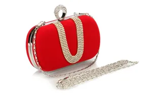 Red velvet evening clutch detail, rhinestone U-shaped strap, silver chain accessory view