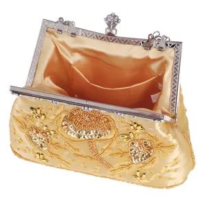 Gold beaded evening clutch bag detail, vintage embroidered flower design, elegant banquet purse.
