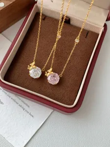 Close-up detail of silver butterfly zircon necklace set, featuring pink and white stones.