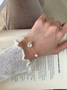 Close-up detail shot of the delicate gold-plated butterfly cubic zirconia bracelet wrist.