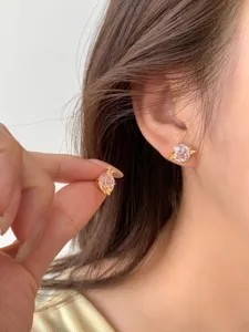 Stunning pink zircon butterfly stud earrings in silver, elegant niche design detail shot.