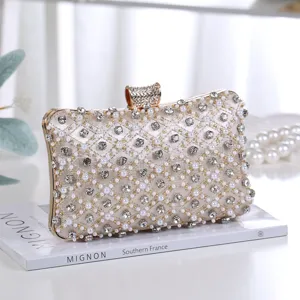 Elegant evening clutch bag for women with pearls and rhinestones on satin, gold metal clasp design.