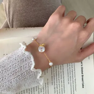 Exquisite gold-plated butterfly zircon bracelet with elegant pearl details for women.