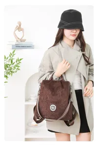 Details of women's fashion backpack with soft brown leather and vintage pattern strap.