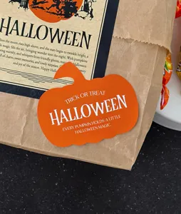 Halloween pumpkin sticker detail view showing packaging and festive paper card design.