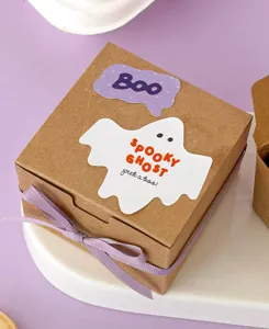 Halloween kraft gift box with cute ghost stickers and purple ribbon for holiday treats.