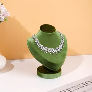 Green velvet necklace display bust detail, elegant jewelry showcase stand for retail and home.