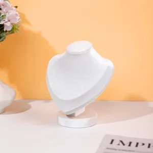 Detailed view of white velvet necklace display stand, elegant bust mannequin for jewelry.