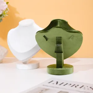 Velvet necklace display stand detail, green and white bust holder for jewelry display.