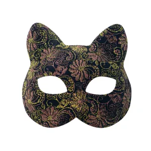 Detail view of the black masquerade cat mask with shimmering gold floral glitter patterns.