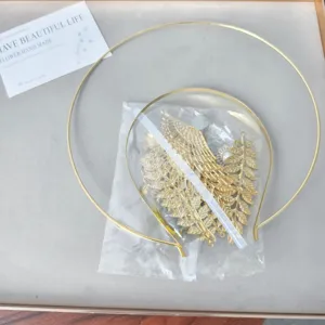 Detailed view of DIY halo headpiece material kit with golden hoops and leaf accessories.