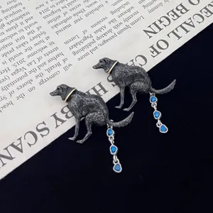 Funny dog poop brooch with blue heart rhinestone tassel, creative metal alloy jewelry accessory.