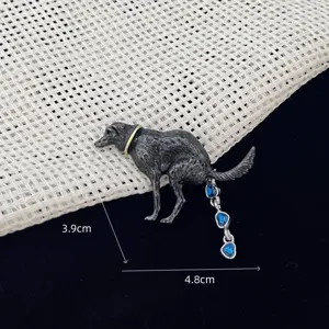 Close-up detail of the funny dog novelty brooch featuring sparkling blue crystal heart drops.