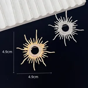 Elegant sunburst brooch with sparkling rhinestones, vintage metal coat pin accessory.