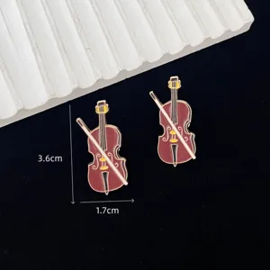 Exquisite metal violin brooch detail showing fine craftsmanship and vintage musical instrument design.