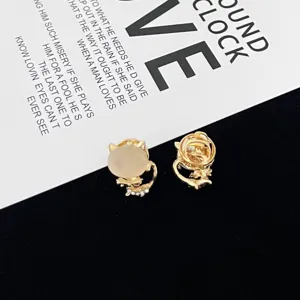 Gold cat brooch pin with opal stone elegant coat accessory for women chic jewelry detail shot