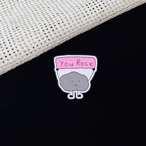 Cute cartoon rock enamel pin with You Rock message, perfect for backpacks, clothes and hat decor.