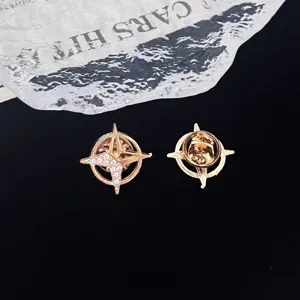 Closeup view of gold hexagram brooch featuring rhinestone crystal details and secure back pin.